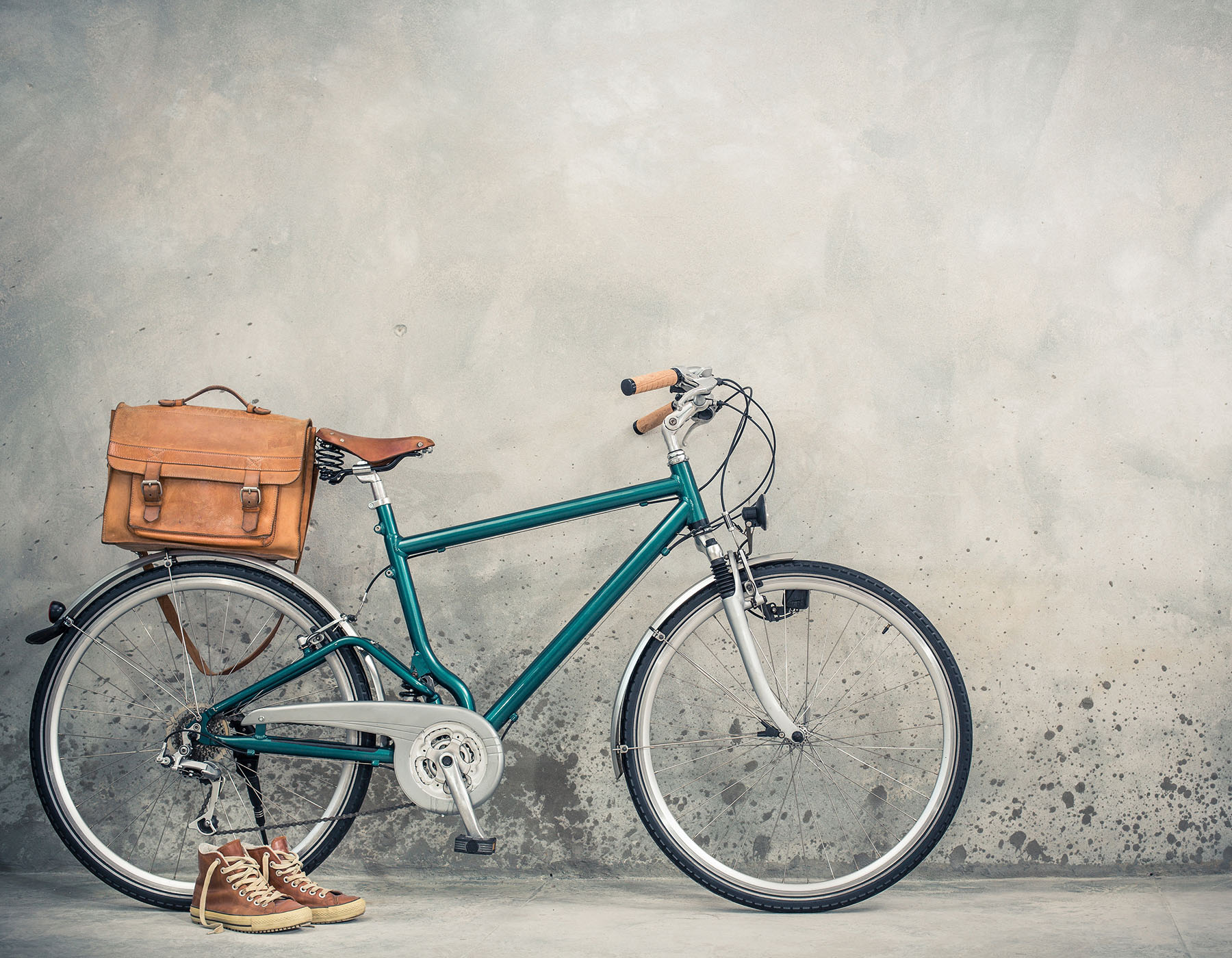 Retro bike with aged leather postman's bag and old sneakers fron