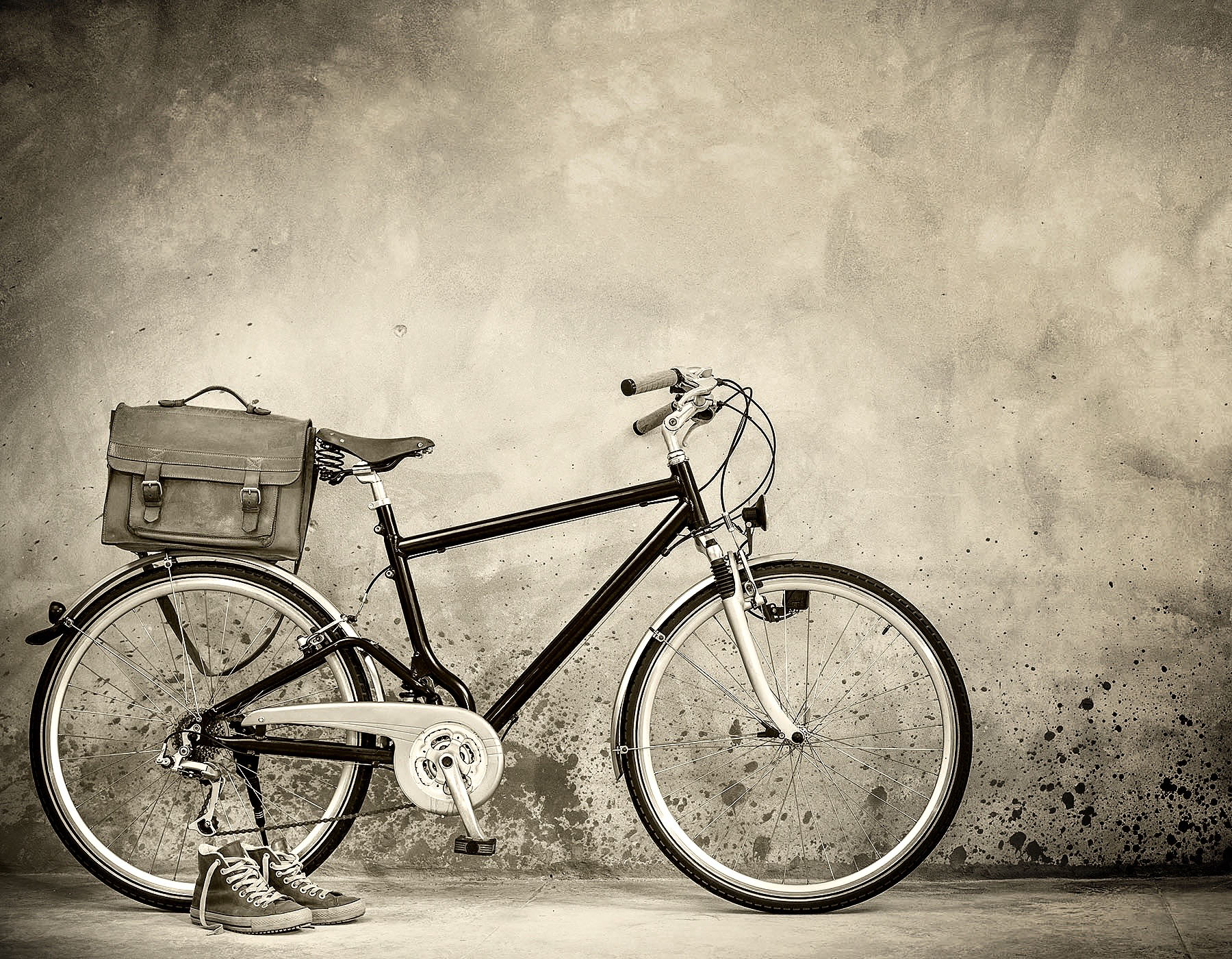 Retro bike with aged leather postman's bag and old sneakers fron