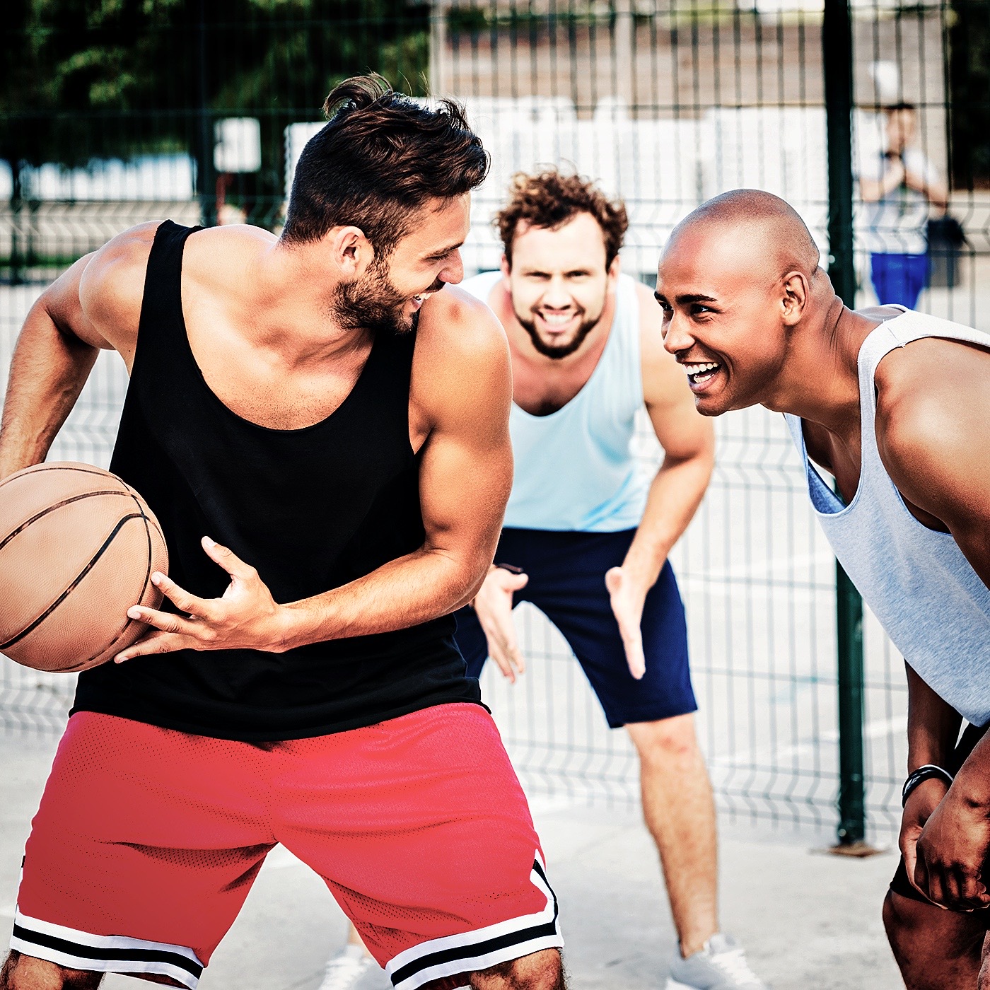 multiethnic group of basketball players playing basketball on court