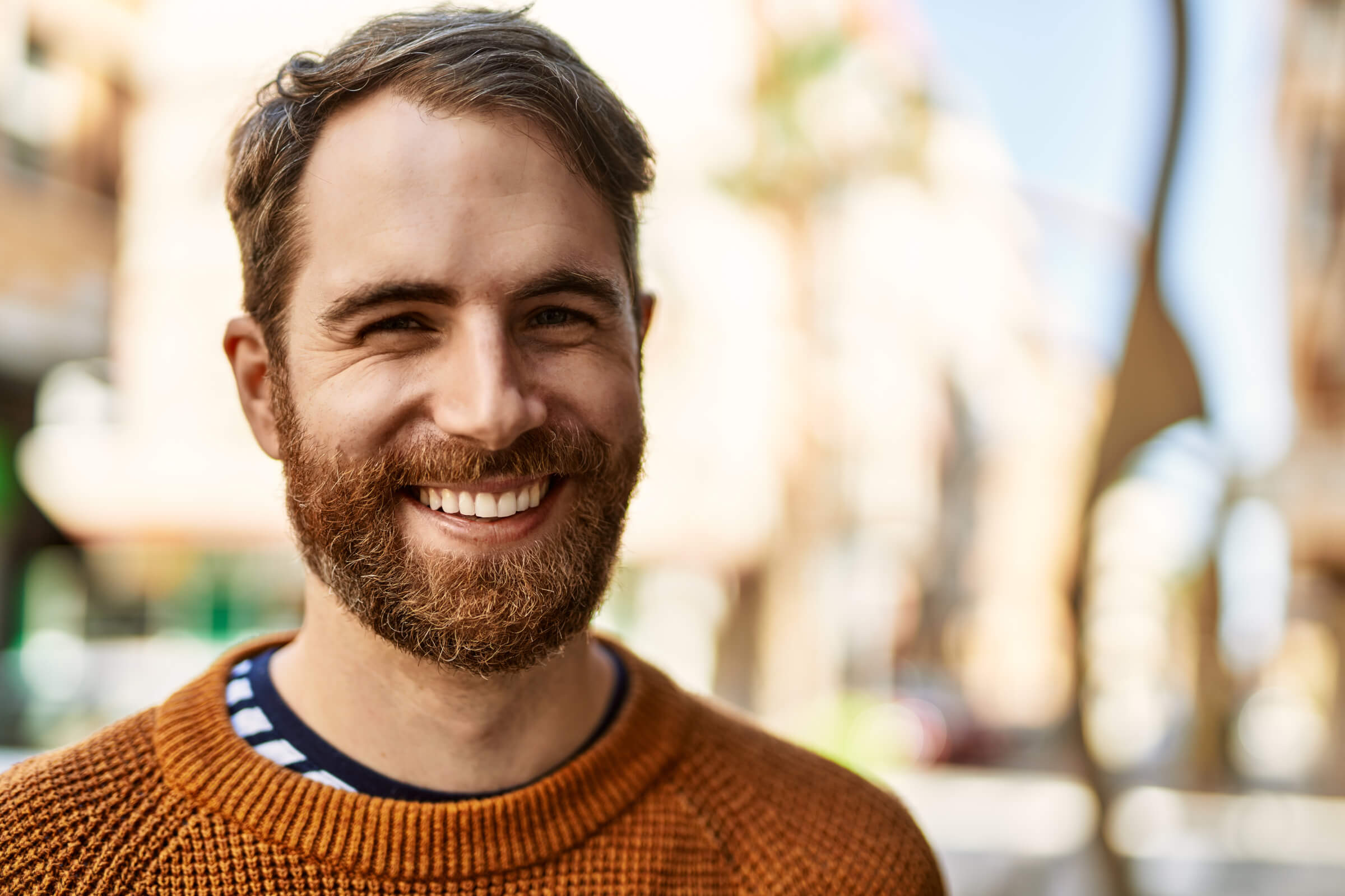 Young caucasian man with beard outdoors on a sunny day