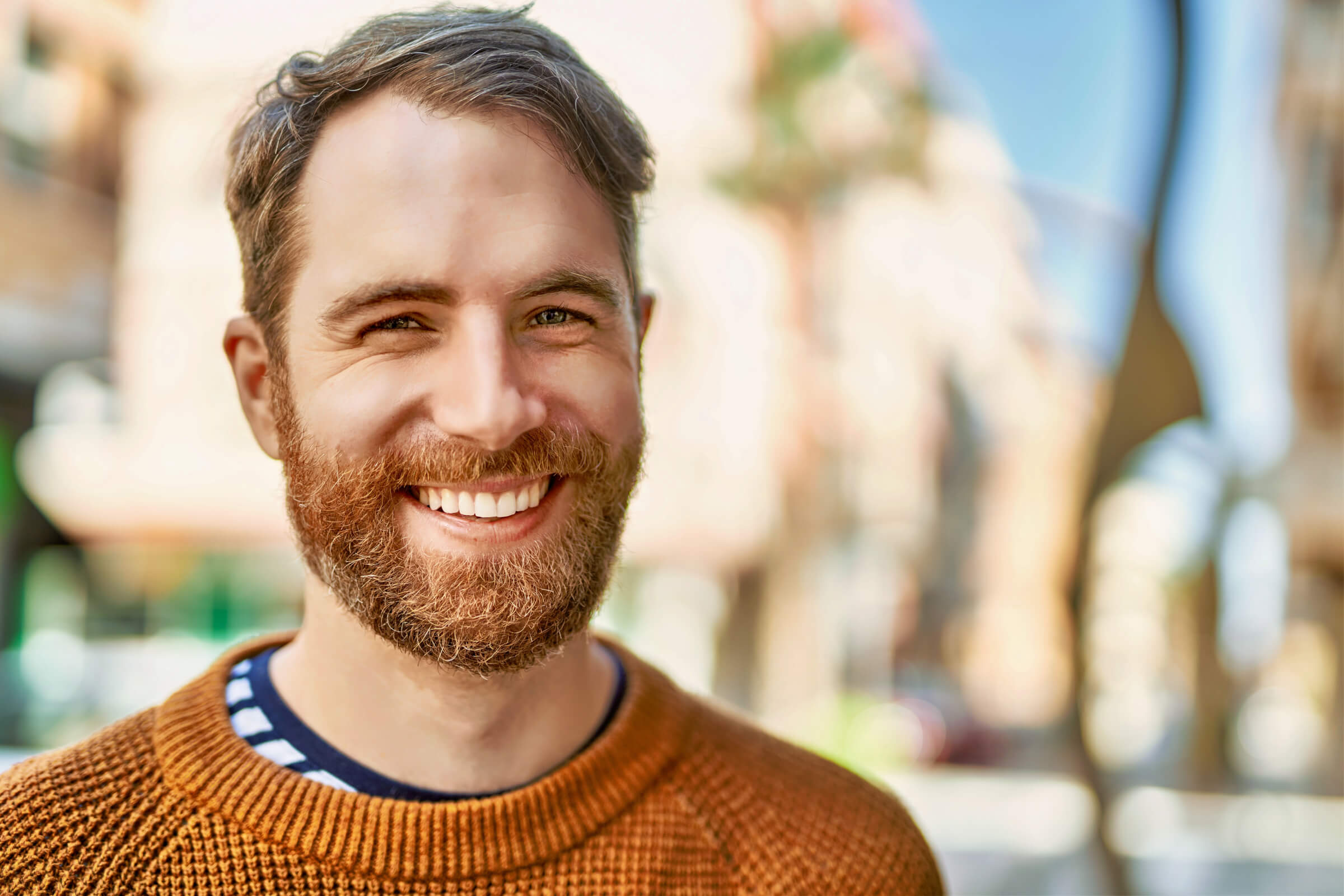 Young caucasian man with beard outdoors on a sunny day