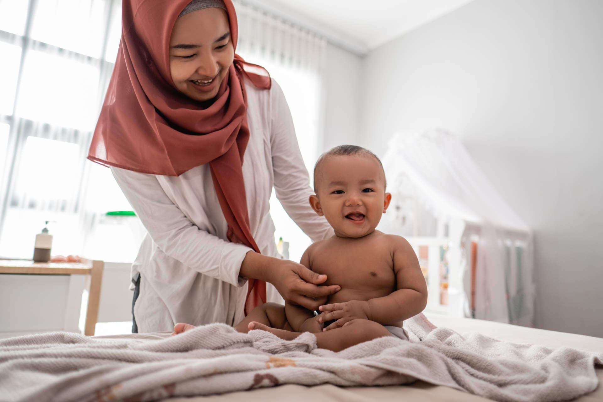 cute little baby boy with mother after taking a bath