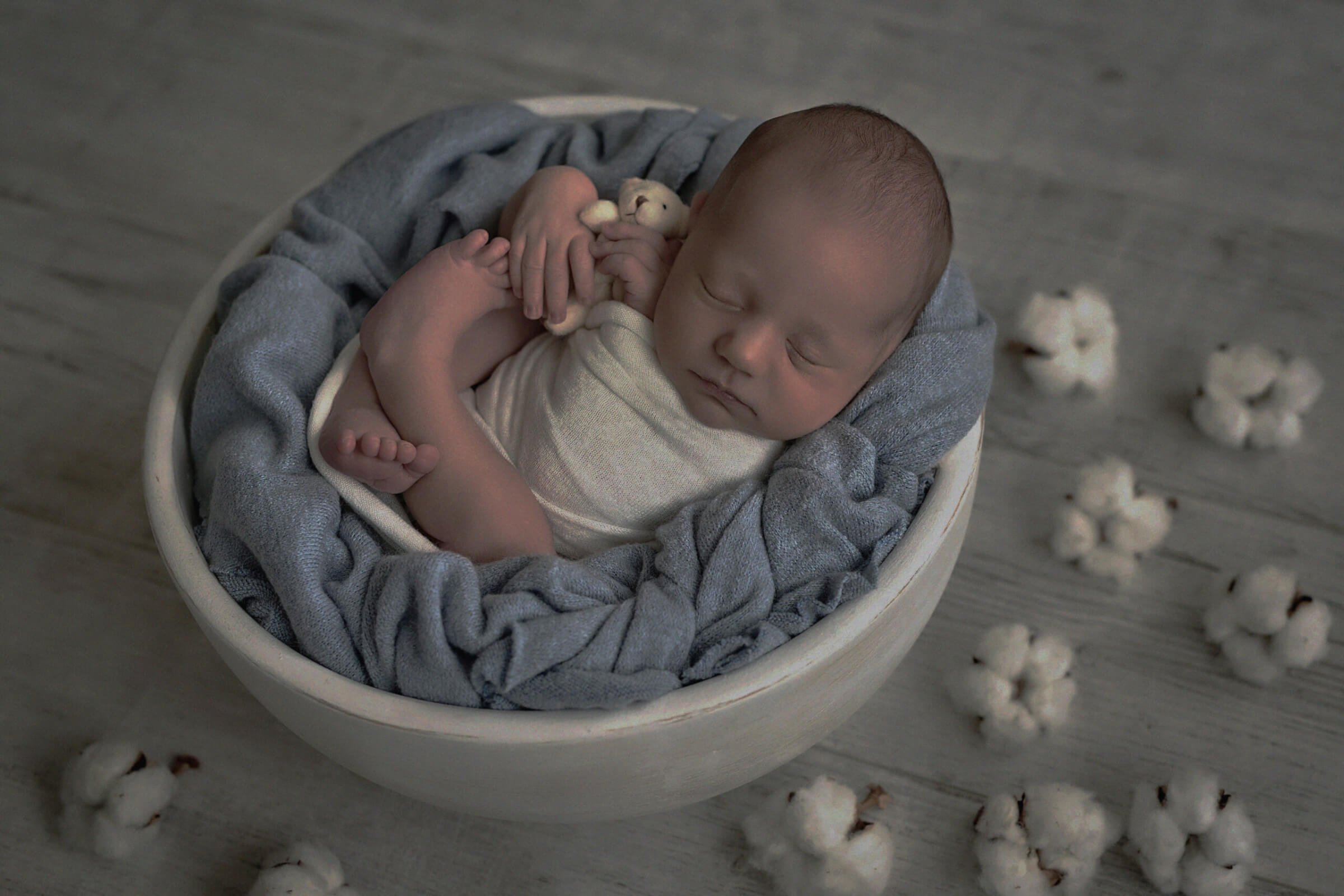 Cute newborn little boy sleeping in crib with toys. Baby goods p